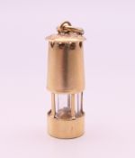 A 9 ct gold Davey Lamp miners lamp charm/pendant. 2 cm high. 2.4 grammes total weight.