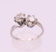A platinum and diamond two stone crossover ring. Ring size P/Q.