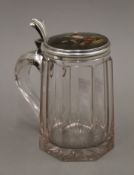 A 19th century Continental silver lidded tankard, the lid decorated with a hunting scene. 16.