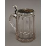 A 19th century Continental silver lidded tankard, the lid decorated with a hunting scene. 16.