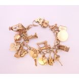 A 9 ct gold charm bracelet. 17 cm long. 65.7 grammes total weight.