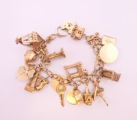 A 9 ct gold charm bracelet. 17 cm long. 65.7 grammes total weight.