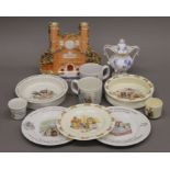 A quantity of Bunnykins, Beatrix Potter porcelain and a Staffordshire Trinity College flat back.