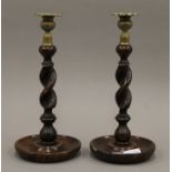A pair of brass mounted oak barley twist candlesticks. 31 cm high.
