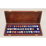A boxed set of enamelled silver heraldic shield badges (one lacking).