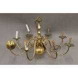 Three brass chandeliers. The largest 82 cm high.