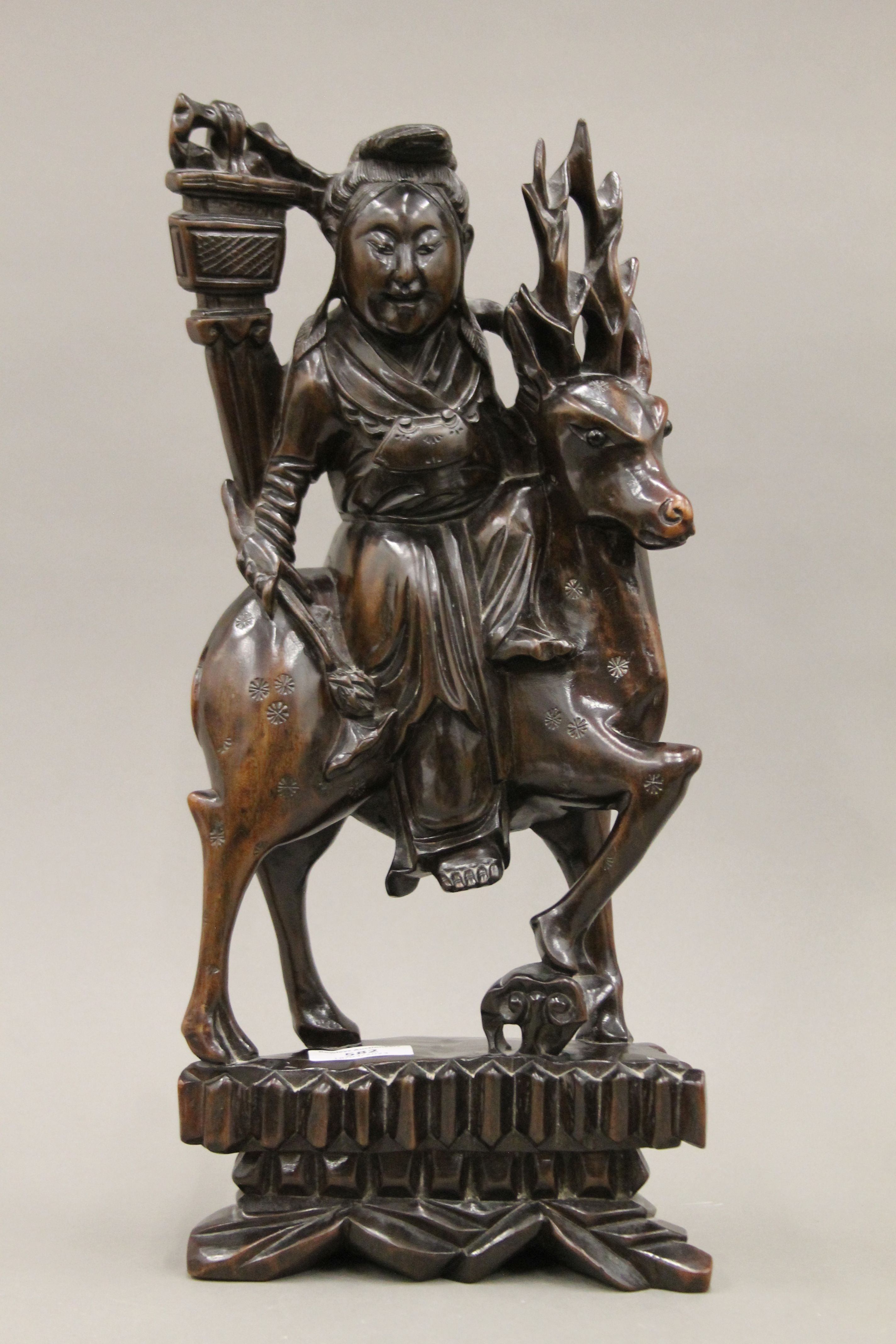 A pair of late 19th/early 20th century Chinese hardwood carvings depicting Guanyin riding a deer. - Image 2 of 4