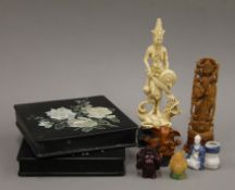 A carved Indian deity figure, a Chinese model of a deity and other various Oriental items.