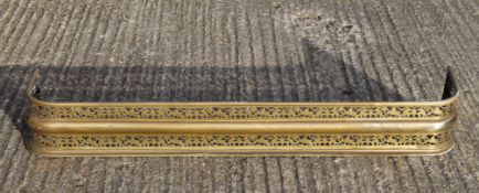 A Victorian pierced brass fender. 126 cm wide.