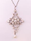 An Edwardian unmarked white gold or platinum diamond and pearl set floral pendant on chain.
