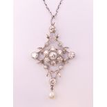 An Edwardian unmarked white gold or platinum diamond and pearl set floral pendant on chain.