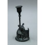 A bronze candlestick formed as a mouse reading a book. 15.5 cm high.