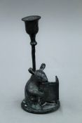 A bronze candlestick formed as a mouse reading a book. 15.5 cm high.