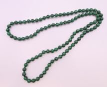 A string of malachite beads. 92 cm long.