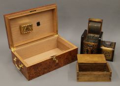 A humidor and two cigarette boxes. The former 37 cm wide.
