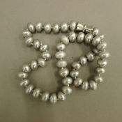 A string of large grey pearls.