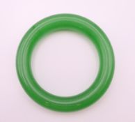 An apple green jade bangle. 5.5 cm internal diameter.