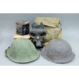 Two tin helmets and four gas masks, mainly WWII army and civilian.