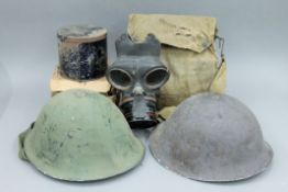 Two tin helmets and four gas masks, mainly WWII army and civilian.