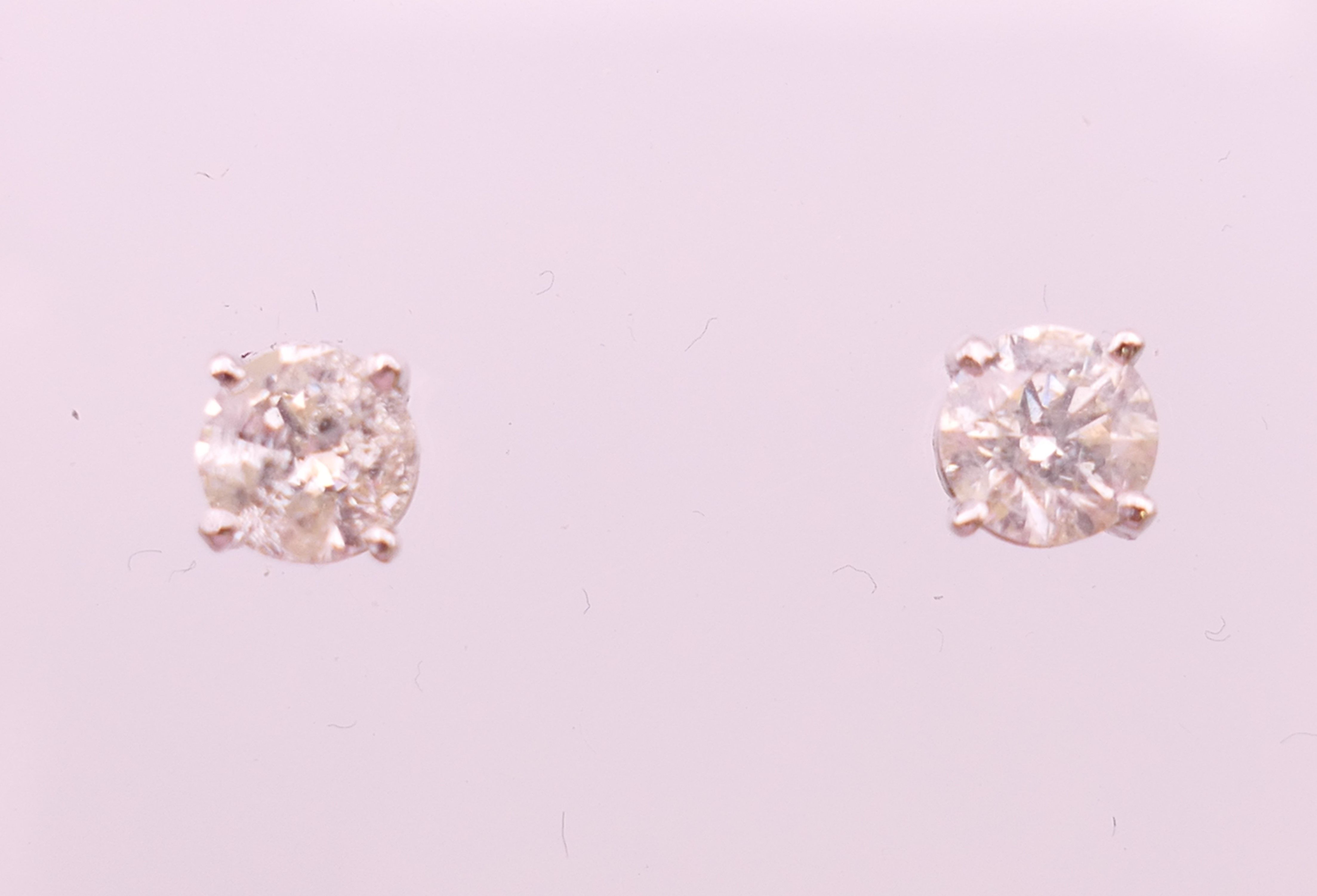 A pair of 18 ct white gold diamond stud earrings. Total diamond weight approximately 1.1 carats.