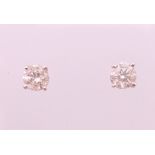 A pair of 18 ct white gold diamond stud earrings. Total diamond weight approximately 1.1 carats.