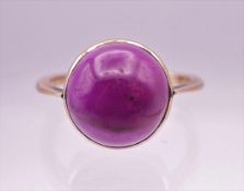 A 9 ct gold cabochon amethyst ring. Ring size N/O.