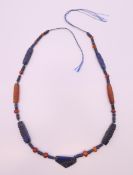 A lapis and carnelian necklace. Approximately 60 cm long.