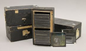 Four boxes of antique lantern slides.