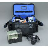 A Contax camera, a camera bag and additional lenses.