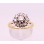 An 18 ct gold diamond flower head ring. Ring size N. 3.8 grammes total weight.