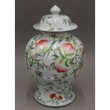 A large Chinese lidded jar painted with peaches, etc., with four character mark to base.