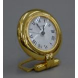 A Cartier desk clock. 8 cm diameter.