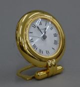 A Cartier desk clock. 8 cm diameter.