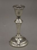 A silver candlestick, hallmarked for Birmingham 1954. 15 cm high.