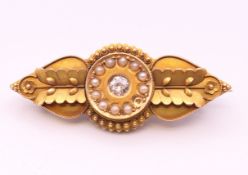 A Victorian unmarked gold diamond and seed pearl brooch. 4.5 cm long. 6.4 grammes total weight.