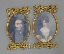 A pair of gilt framed miniatures. 23.5 cm high.