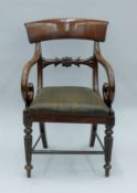 A Victorian mahogany open arm chair. 52 cm wide.