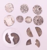 A collection of silver medieval coins. Largest approximately 2 cm diameter.