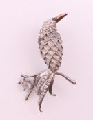 A gold backed and silver diamond bird brooch. 3.5 cm high.