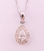 An 18 ct white gold diamond pear shaped pendant necklace. Total diamond weight approximately 0.