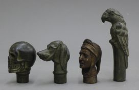 Four bronze walking stick handles.