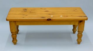 A pine coffee table. 121 cm long.