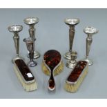 A quantity of various silver bud vases, silver and tortoiseshell brushes, etc.
