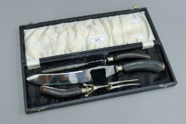 A cased antler handled carving set.