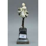 An Art Deco bronze and ivory figurine mounted on a marble plinth. 21.5 cm high.