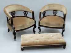 Two Victorian upholstered tub chairs and a foot stool. The former 62 cm wide.