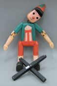 A large wooden Pinocchio puppet. Approximately 90 cm high.
