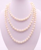 A string of pearls. Approximately 120 cm long.