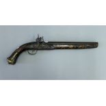 A 19th century Eastern brass inlaid flintlock pistol. 44 cm long.