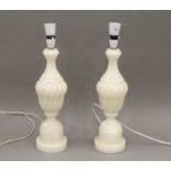 A pair of alabaster table lamps. 50 cm high overall.